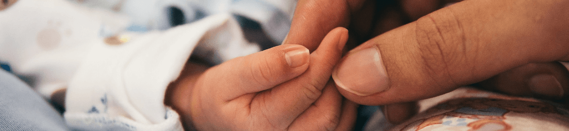 Child and parent holding hands